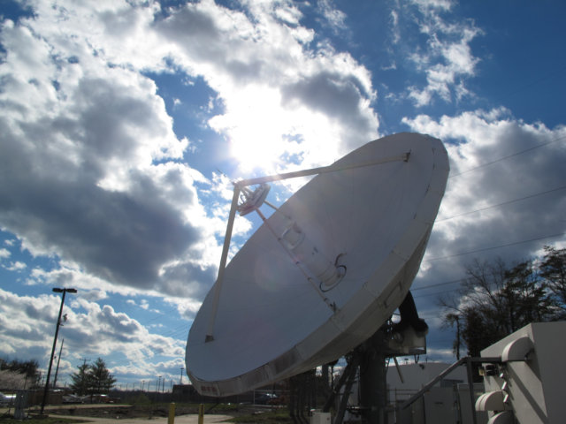 Large satellite dish, with a beautiful sky background.