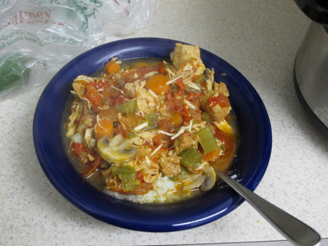 A bowl of homemade chicken stew over mashed potatoes.