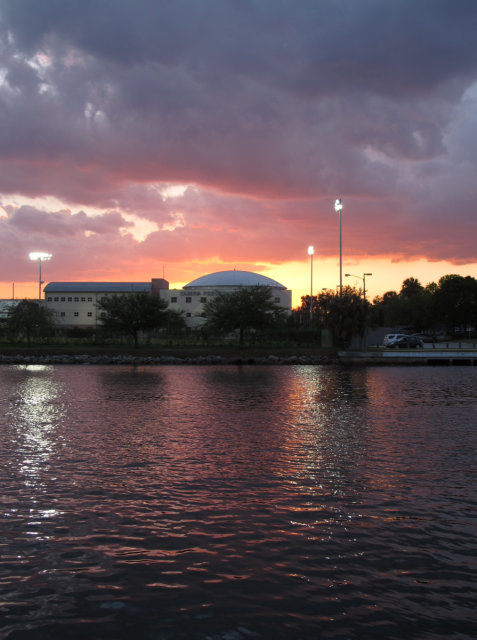 Sun setting behind Tampa Preparatory School, across Hillsborough River