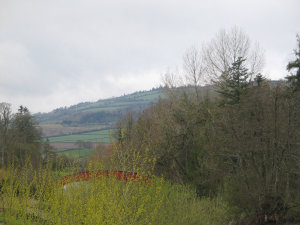 Hills, a bridge, and grass behind the Dolmen Hotel