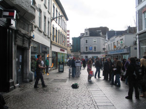 A guy juggles torches in Galway.