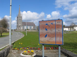 Lawn and church and sign at Mullingar.